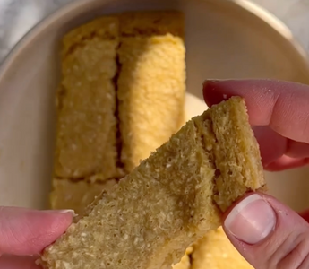 Hand holding golden-brown textured snack bar, ideal for mess-free mealtime
